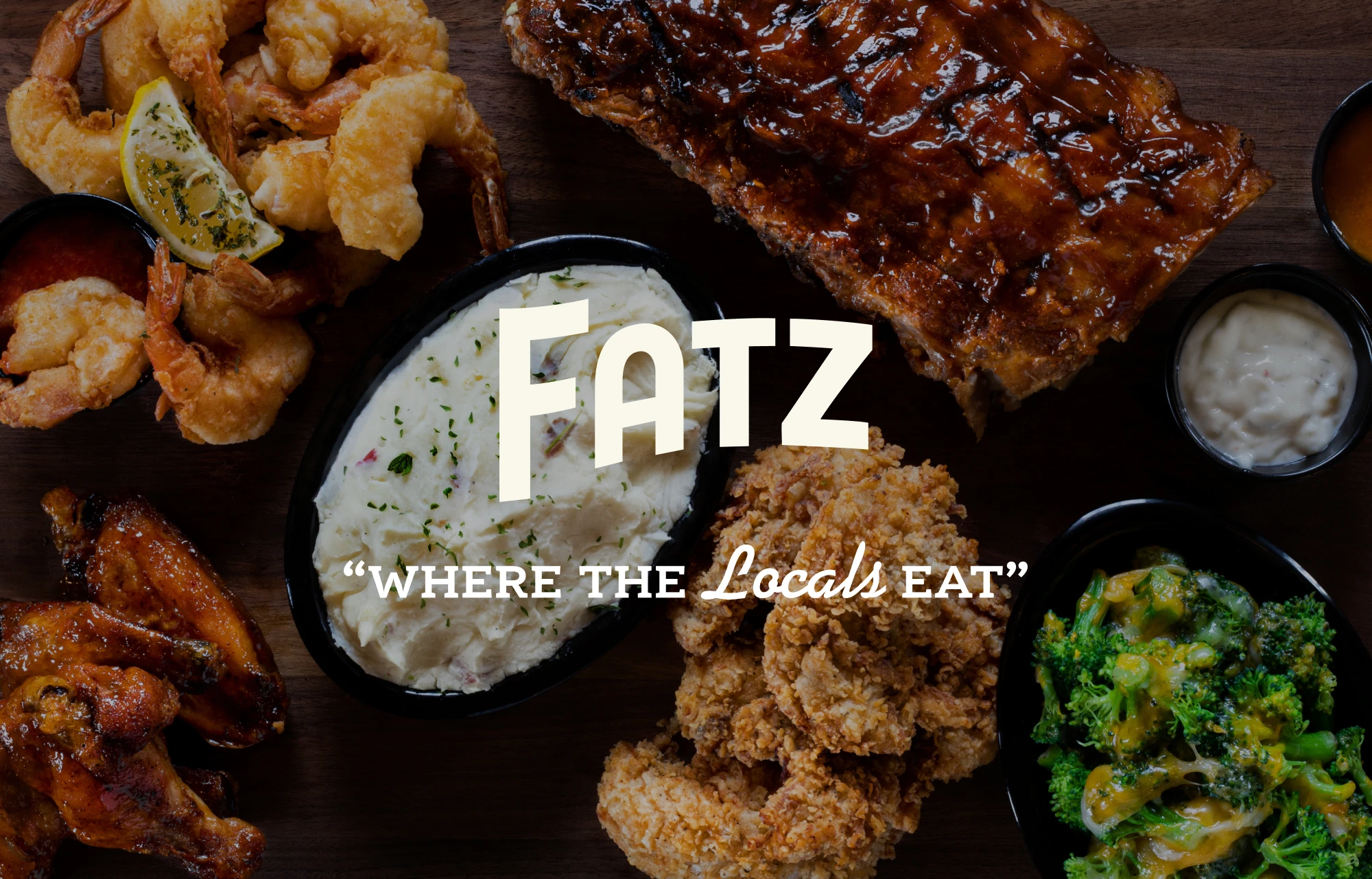 Custom Lettered Fatz Logo with tagline of Where the Locals Eat, over a photo of ribs, chicken, potatoes and more.