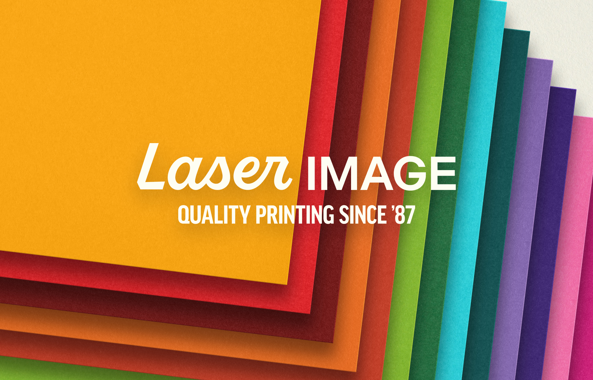 Laser Image logo overlaid a stack of colorful paper