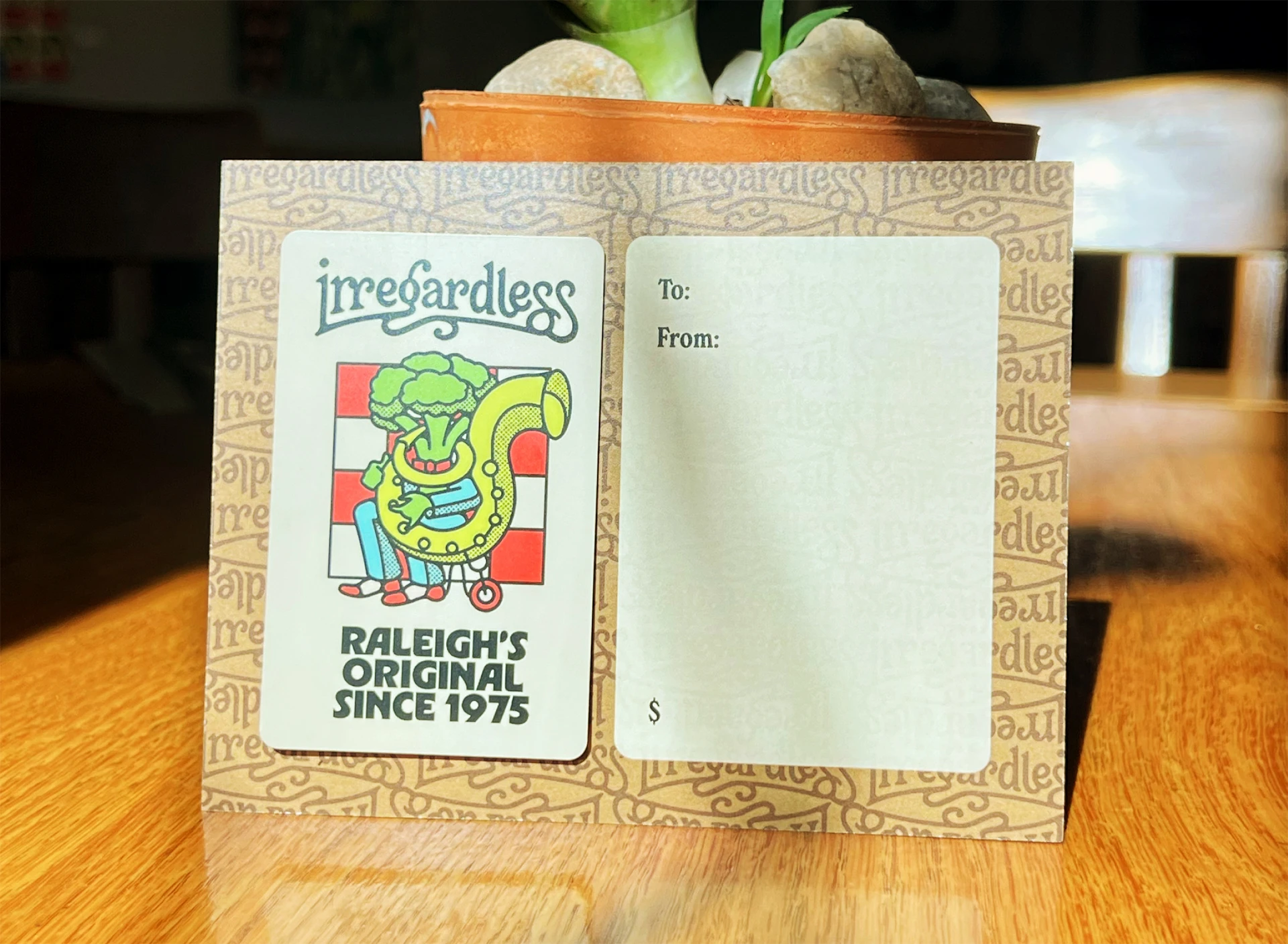A gift card to Irregardless in featuring an illustration of a broccoli playing a horn