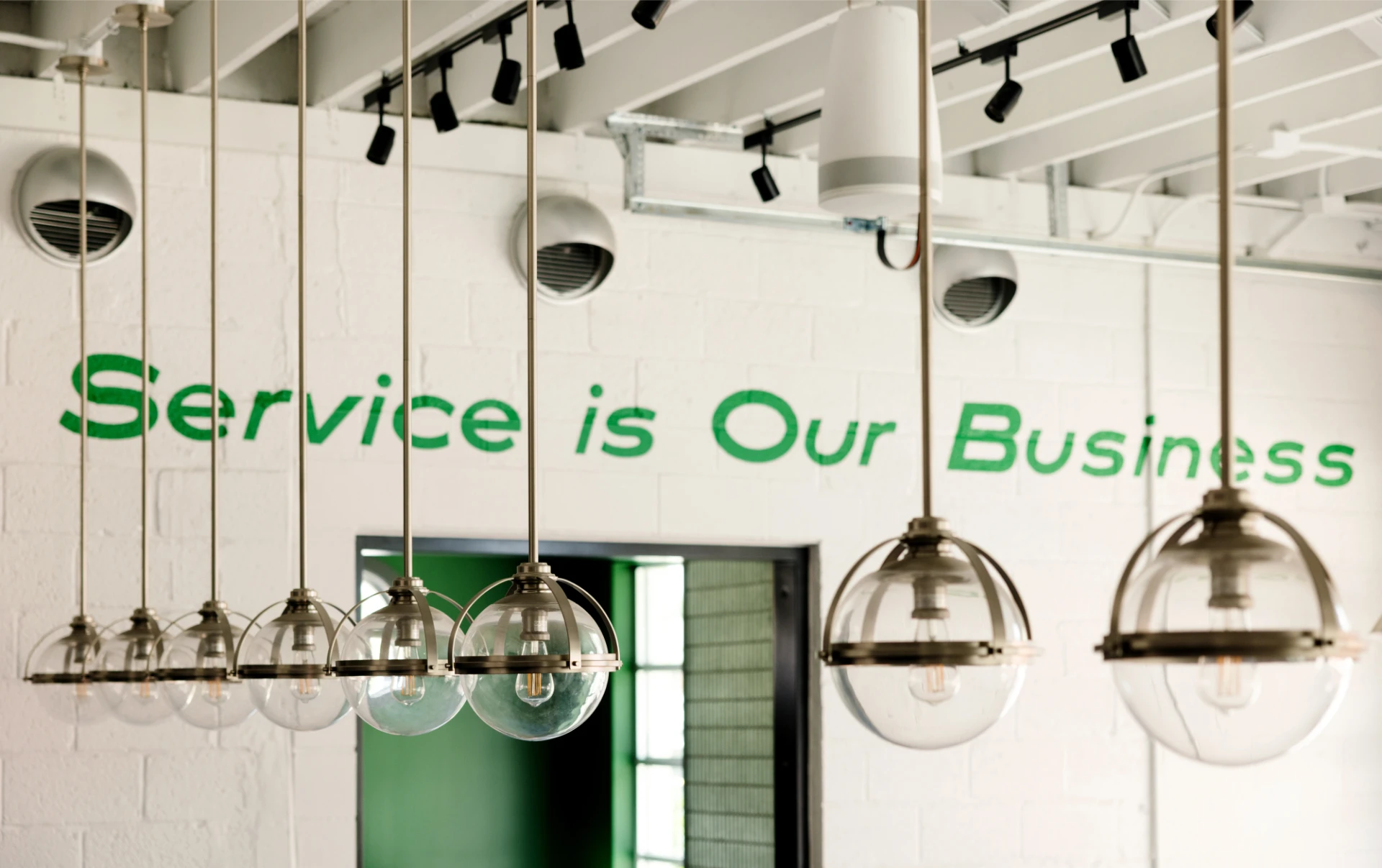 'Service is Our Business' painted on a brick wall inside of Lloyd's restaurant