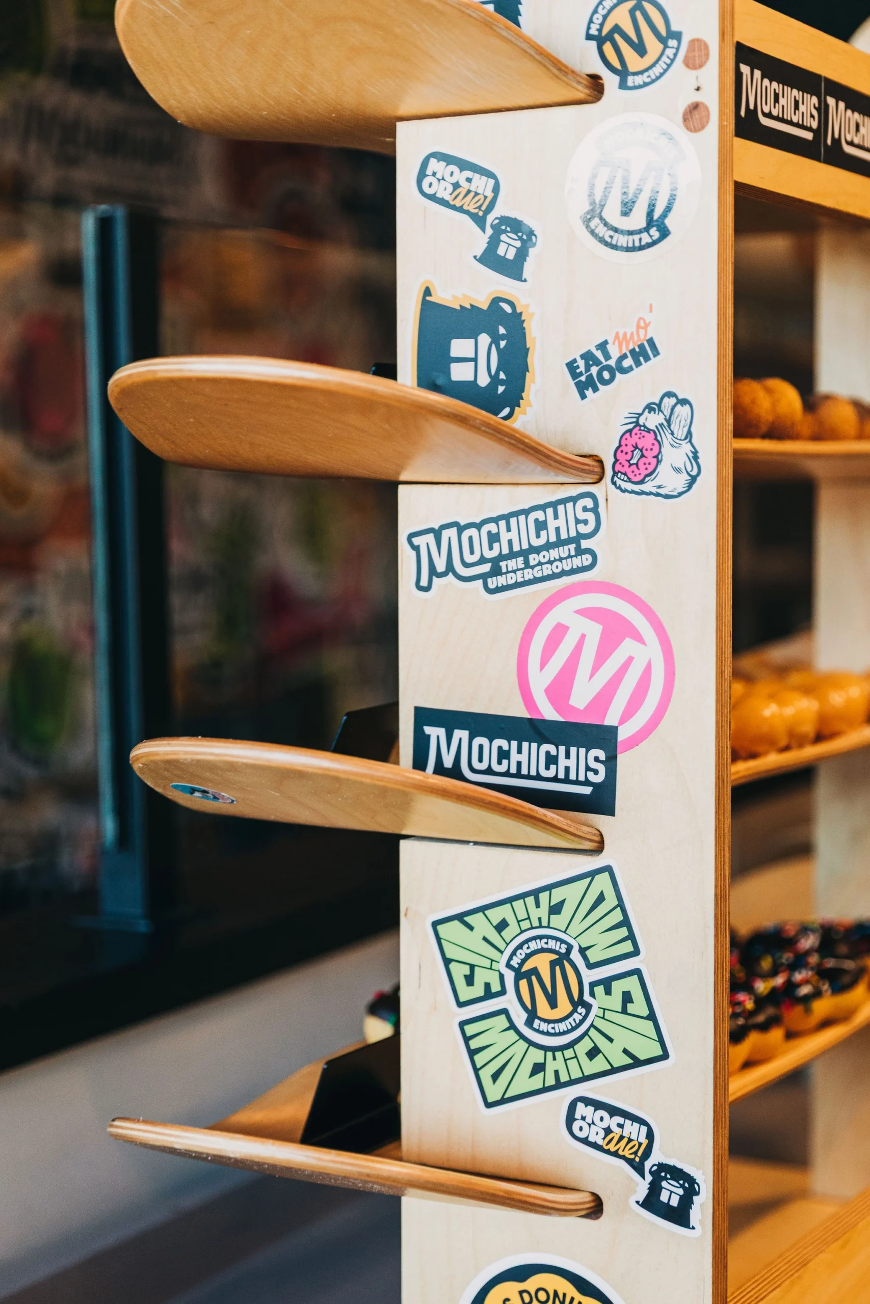 Donut display shelves made out of skateboards and covered in stickers