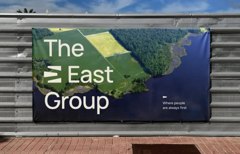 A vinyl banner with an aerial photo of the coast with The East Group logo overlaid