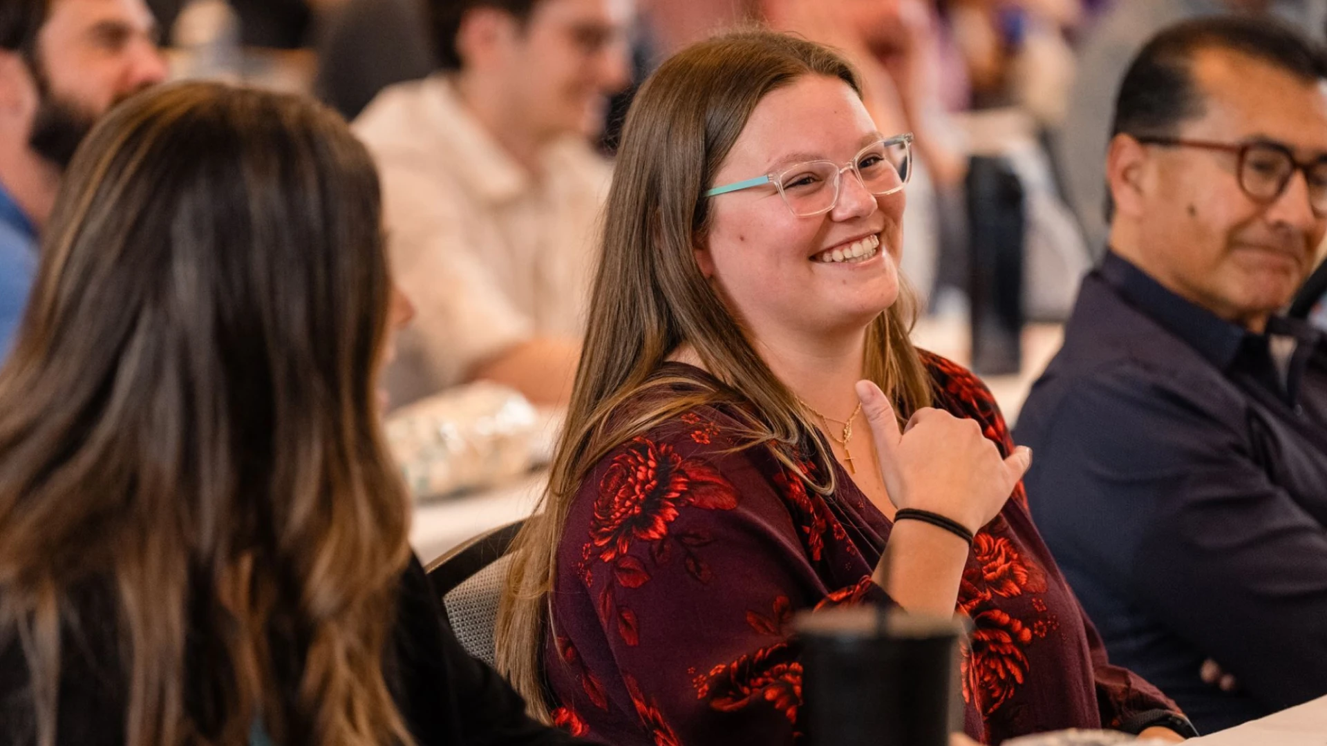 Employees sitting and smiling while listening to a presentation