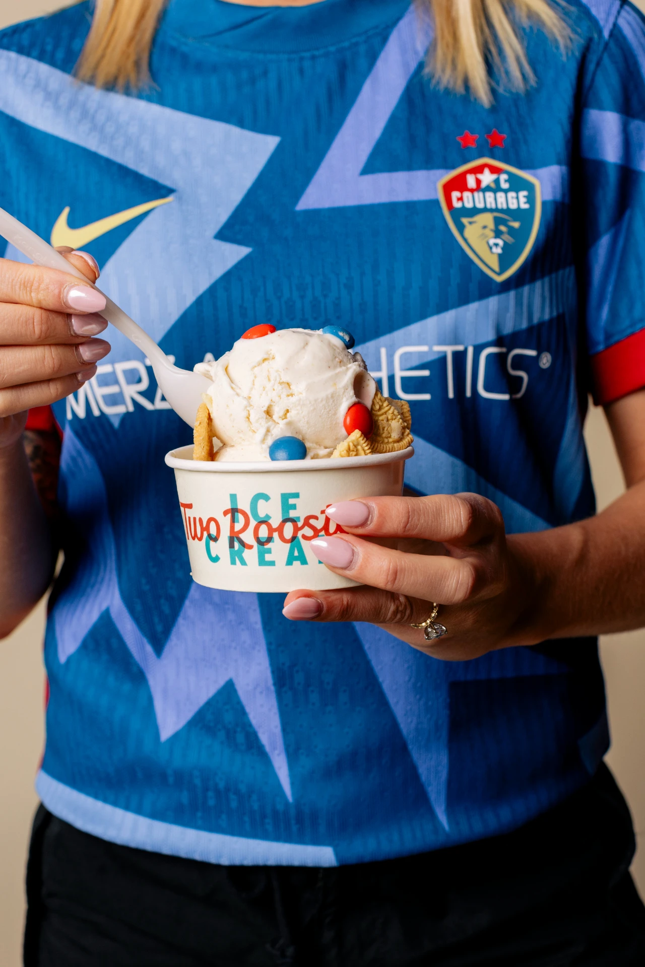 NC Courage soccer player holding a cup of Two Roosters ice cream