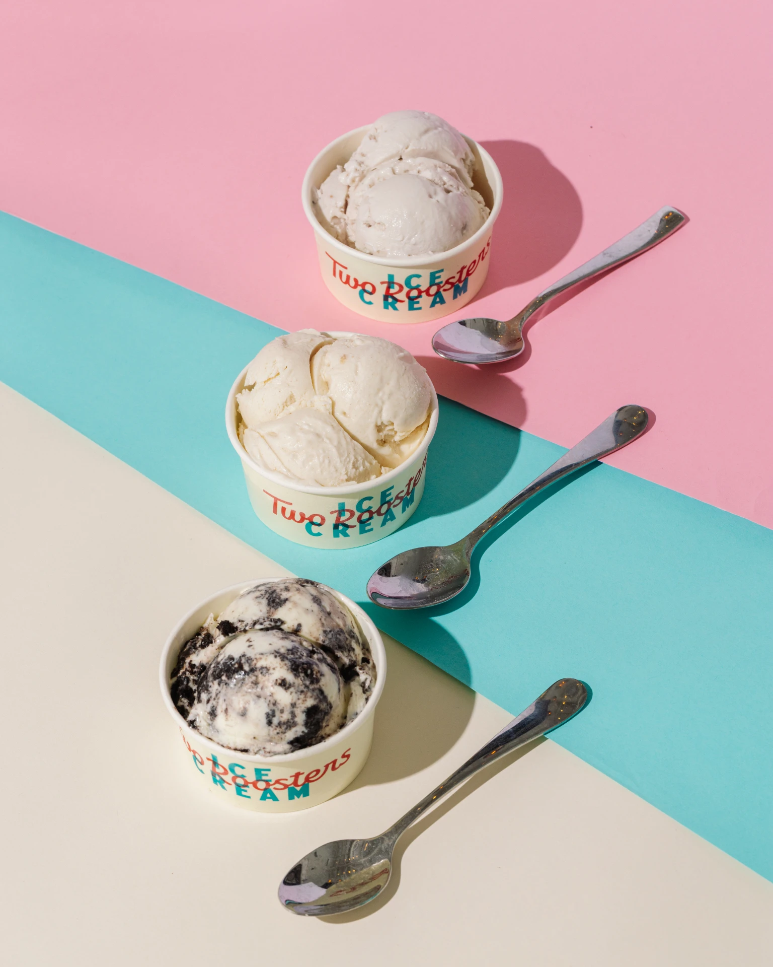 Three scoop cups filled with Two Roosters ice cream