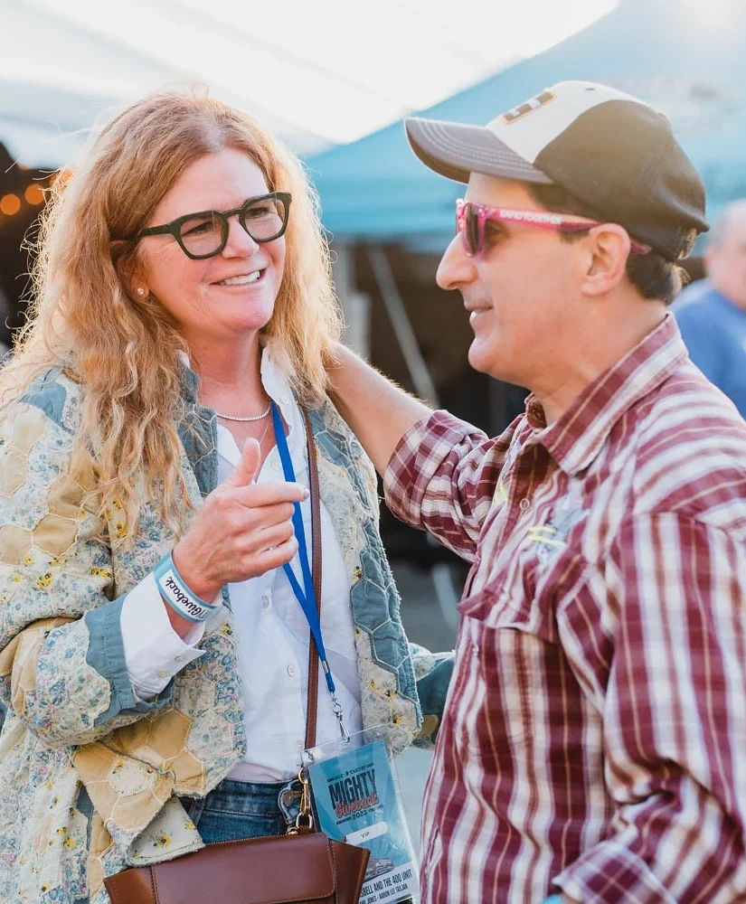 A man and woman talking outside at the Mighty Giveback benefit concert