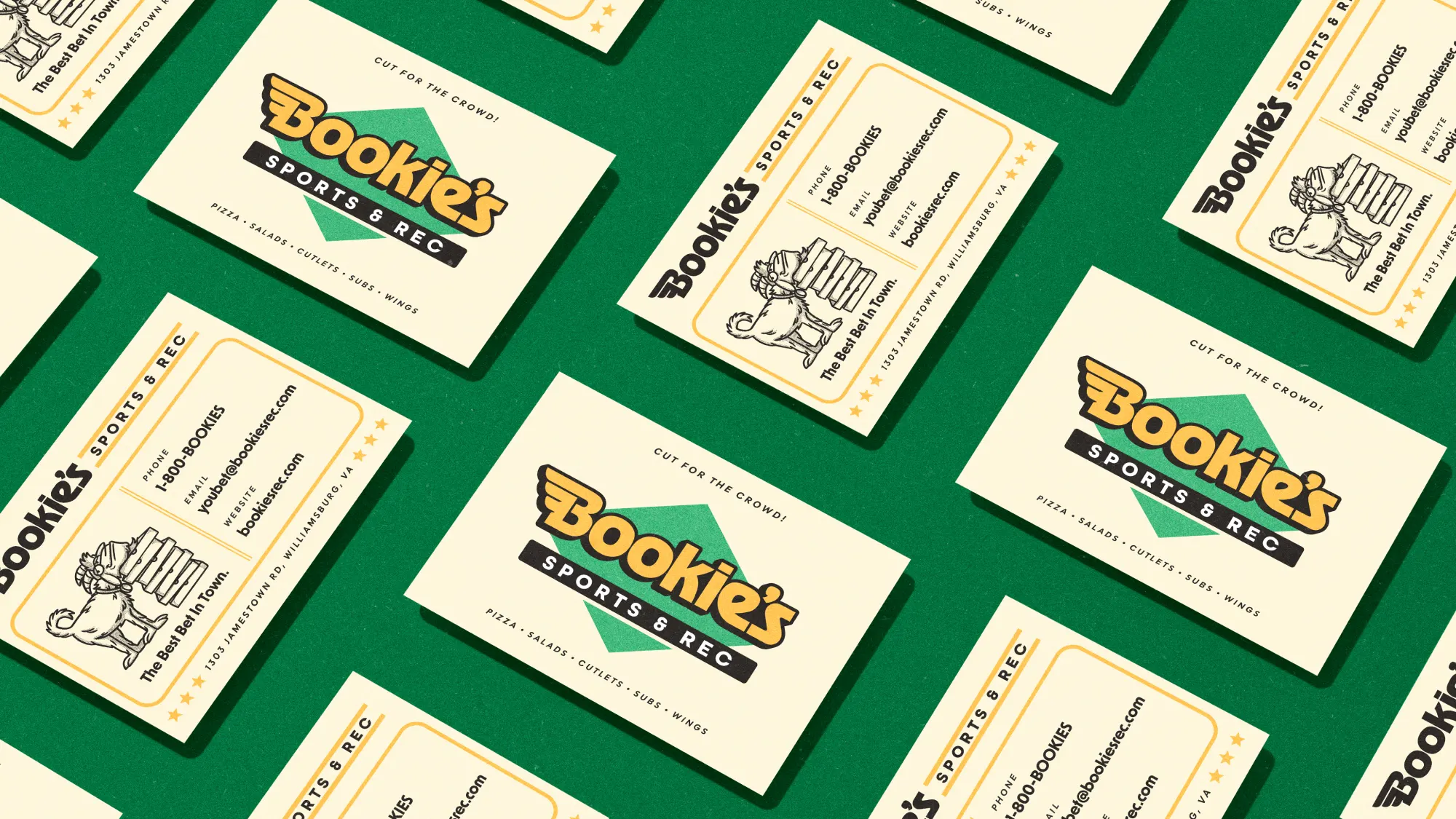 Business cards for Bookie's laid out on a green background