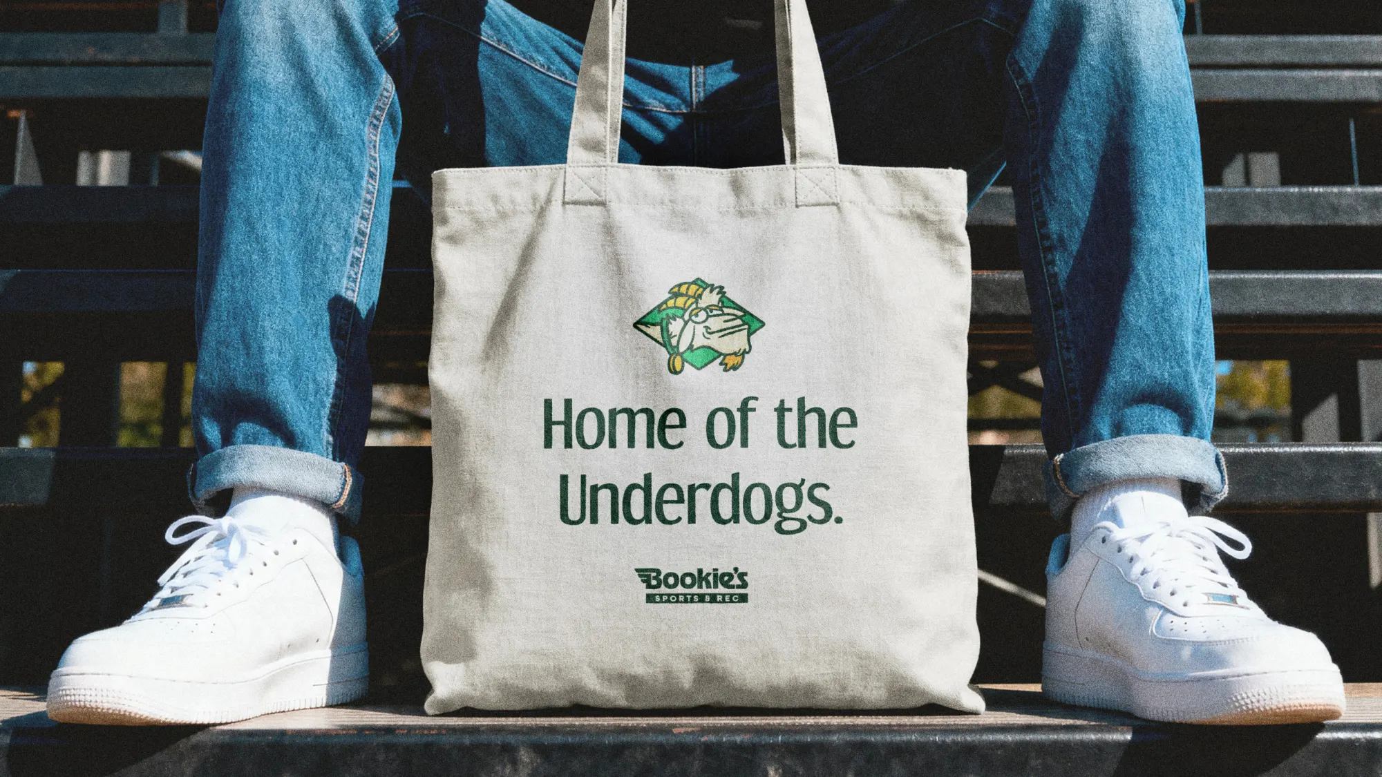 A white tote bag with the tagline 'Home of the Underdogs' on it